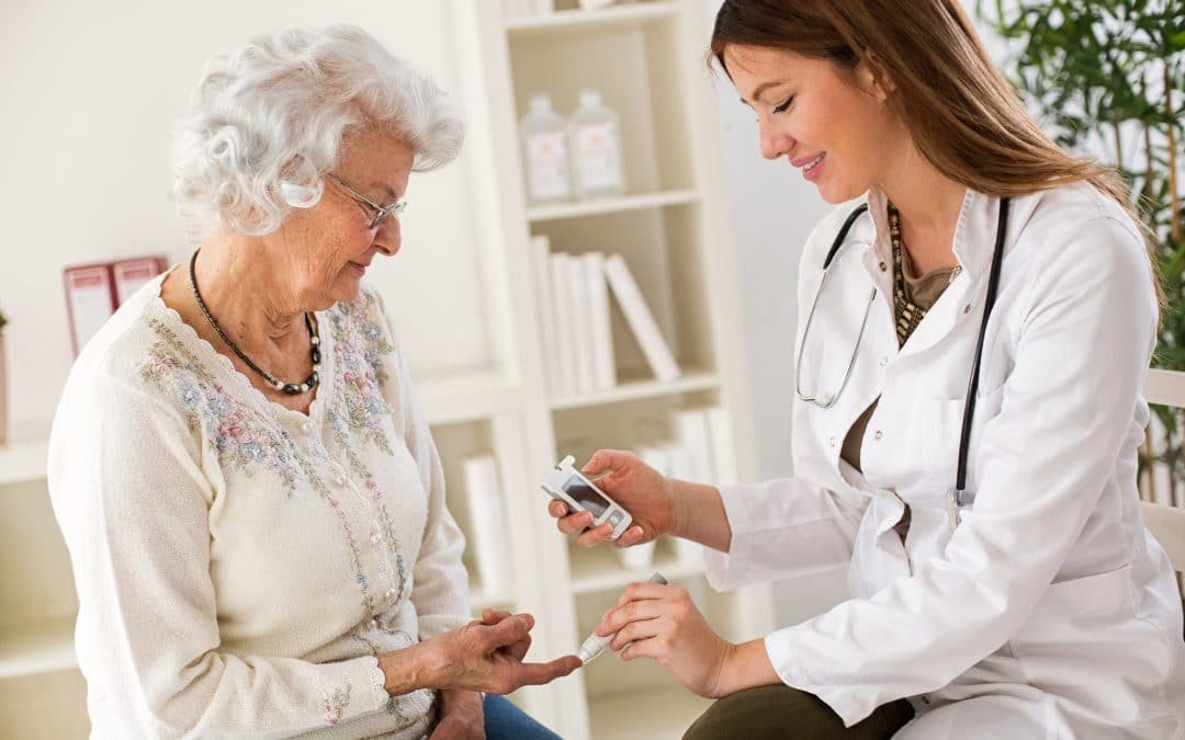 Young female doctor making diabetes blood test on senior woman, closeup