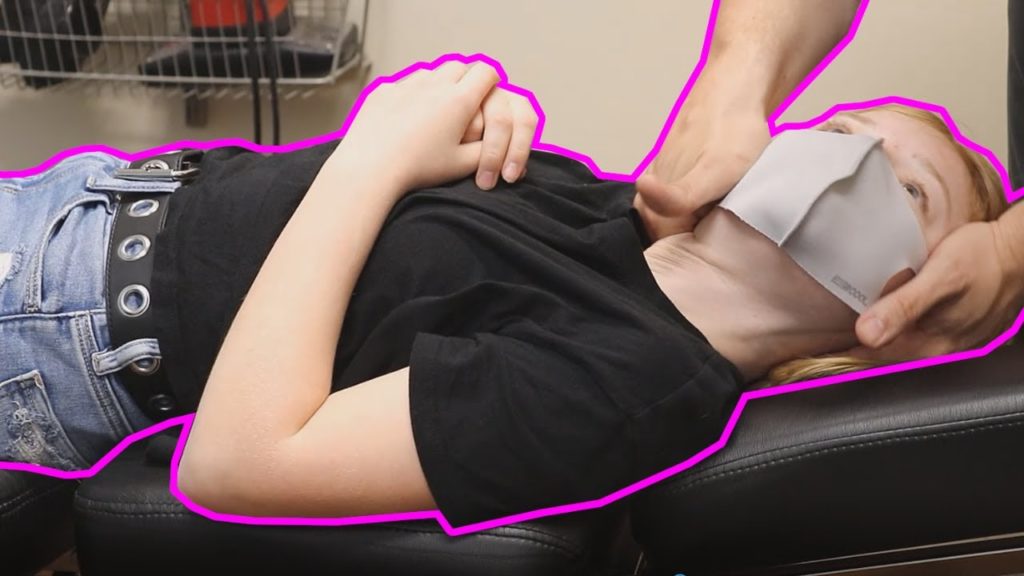 girl in black shirt get's chiropractic adjustment