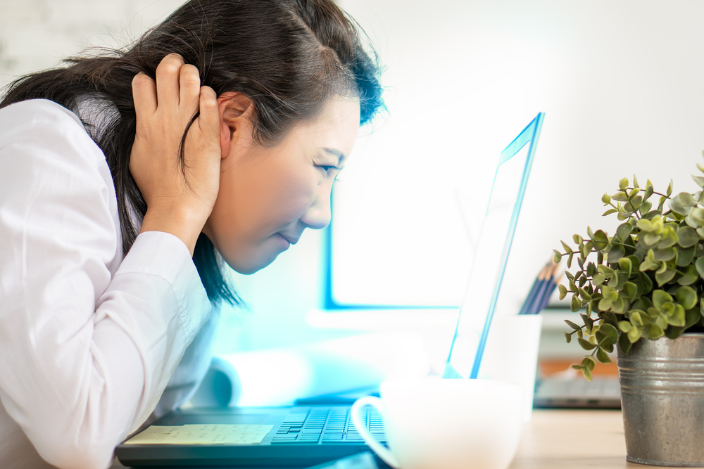 Beautiful female woman work office with technology computer effect blue light screen eyes health problem