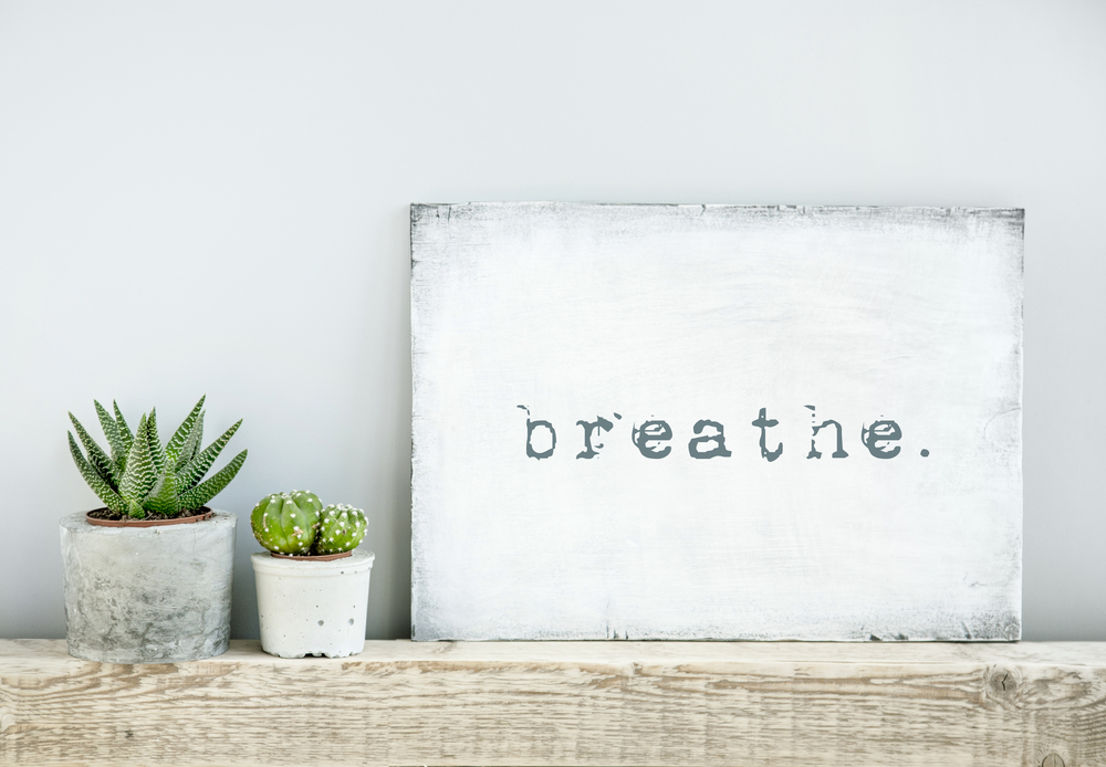 motivational poster quote BREATHE. scandinavian or american style room interior.