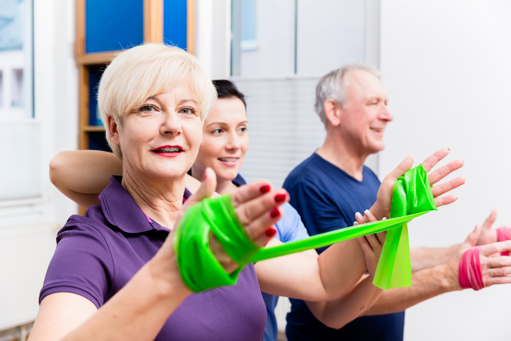 Older patients in physiotherapy using power band for strength training