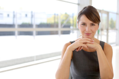 Portrait of attractive businesswoman sitting in modern building