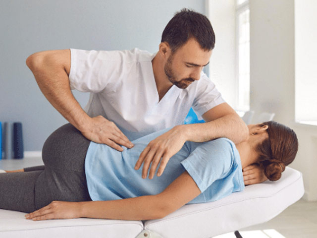 image of a woman having her back adjusted.