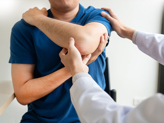 image of a patient having his elbow examined.